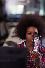 Image showing young woman at office looking at sand  clock