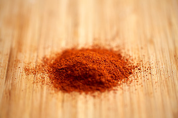 Image showing cayenne pepper or paprika powder on wood