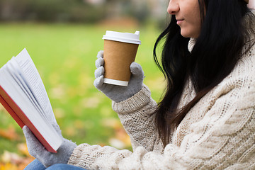 Image showing woman with book drinking coffee in autumn park