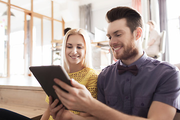 Image showing happy creative team with tablet pc in office