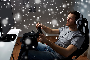 Image showing man playing car racing video game at home