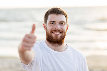 Image showing happy smiling young man on beach