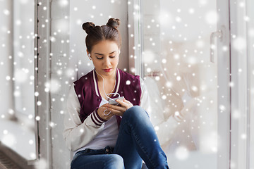 Image showing teenage girl with smartphone and earphones