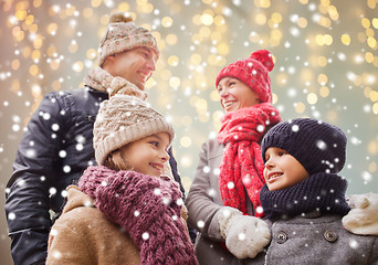 Image showing happy family over christmas lights and snow