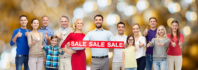 Image showing happy people with sale sign showing thumbs up