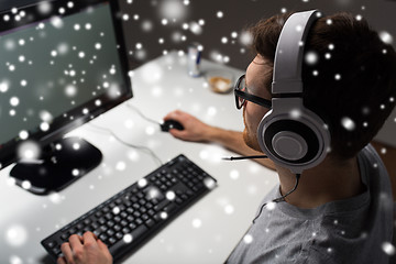 Image showing man in headset playing computer video game