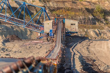 Image showing Long conveyor belt transporting ore