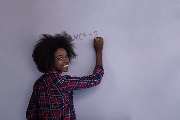 Image showing black  woman writing on a white board  in a modern office