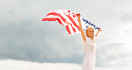 Image showing happy woman with american flag outdoors