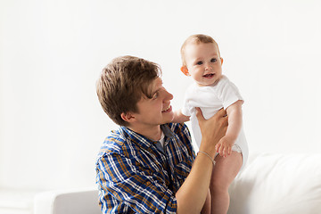 Image showing happy young father with little baby at home