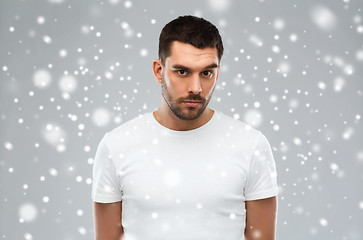 Image showing young man portrait over snow