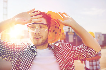 Image showing group of builders in hardhats outdoors