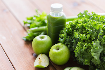 Image showing close up of bottle with green juice and vegetables