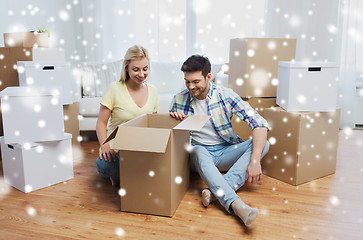 Image showing smiling couple with big boxes moving to new home