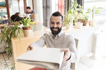 Image showing happy creative male office worker with folfer