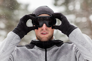 Image showing sports man with ski goggles in winter outdoors