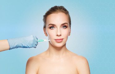 Image showing woman face and hand with syringe making injection