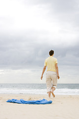 Image showing Woman walking on beach