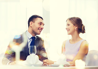 Image showing smiling couple looking at each other at restaurant