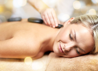 Image showing close up of woman having hot stone massage in spa