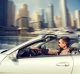 Image showing happy man driving cabriolet car on city 