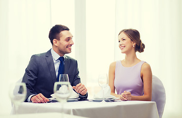 Image showing smiling couple looking at each other at restaurant