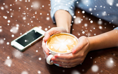 Image showing close up of woman with smartphone and coffee