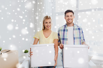 Image showing smiling couple with big boxes moving to new home