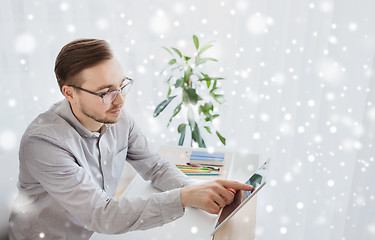 Image showing happy creative male office worker with tablet pc