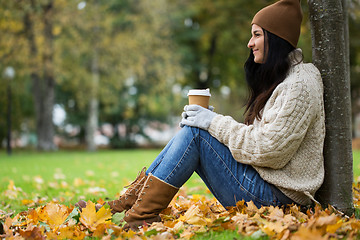 Image showing close up of woman drinking coffee in autumn park