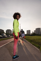 Image showing Portrait of sporty young african american woman running outdoors