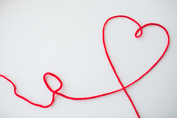 Image showing red knitting yarn thread in shape of heart