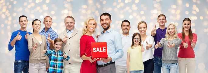 Image showing happy people with sale sign showing thumbs up