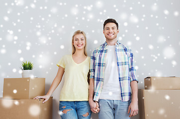 Image showing smiling couple with big boxes moving to new home