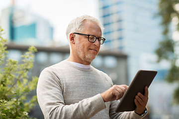 Image showing senior man with tablet pc on city street