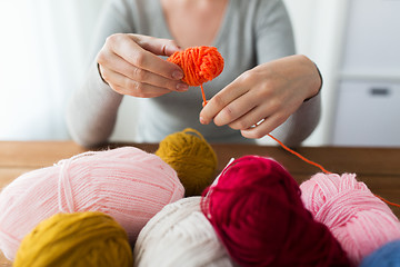 Image showing woman pulling yarn up into ball