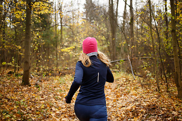 Image showing Woman in pink hat jogging