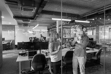 Image showing young couple at modern office interior writing notes on stickers