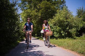 Image showing Young  couple having joyful bike ride in nature