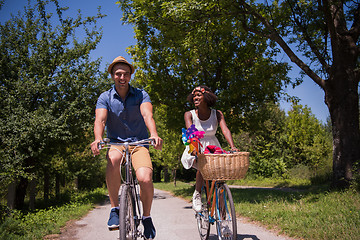 Image showing Young  couple having joyful bike ride in nature