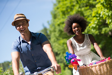 Image showing Young  couple having joyful bike ride in nature