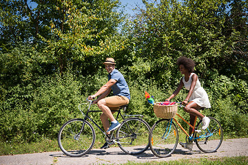 Image showing Young  couple having joyful bike ride in nature