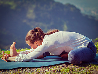 Image showing Woman doing Ashtanga Vinyasa yoga Janu Sirsasana A asana stretch