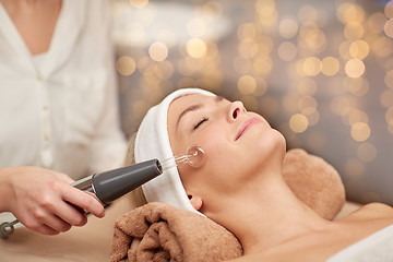 Image showing close up of young woman having face massage in spa