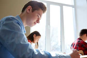 Image showing group of students with books writing school test