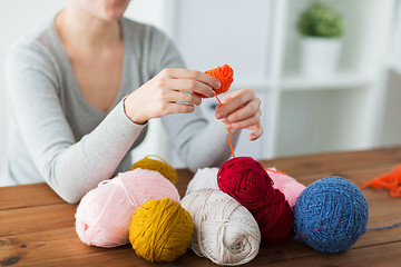 Image showing woman pulling yarn up into ball