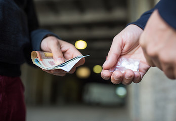 Image showing close up of addict buying dose from drug dealer