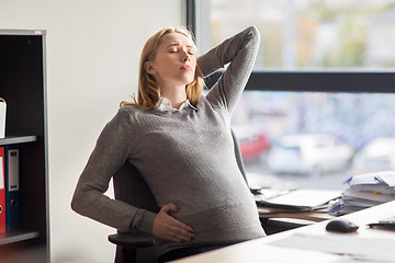 Image showing tired pregnant businesswoman at office work