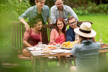 Image showing happy friends having dinner at summer garden party