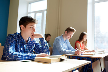 Image showing group of students with books writing school test